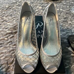 Brand new, in box. Fancy silver shoes with cute sequence detail. Size 6.5.